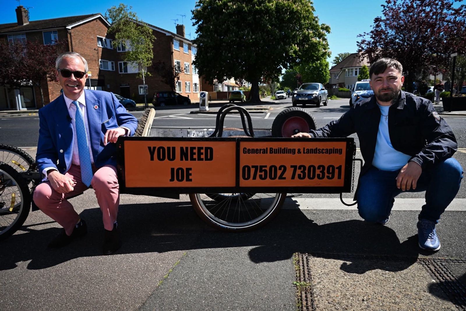 Joe beside the You Need Joe trailer with Nigel Farage