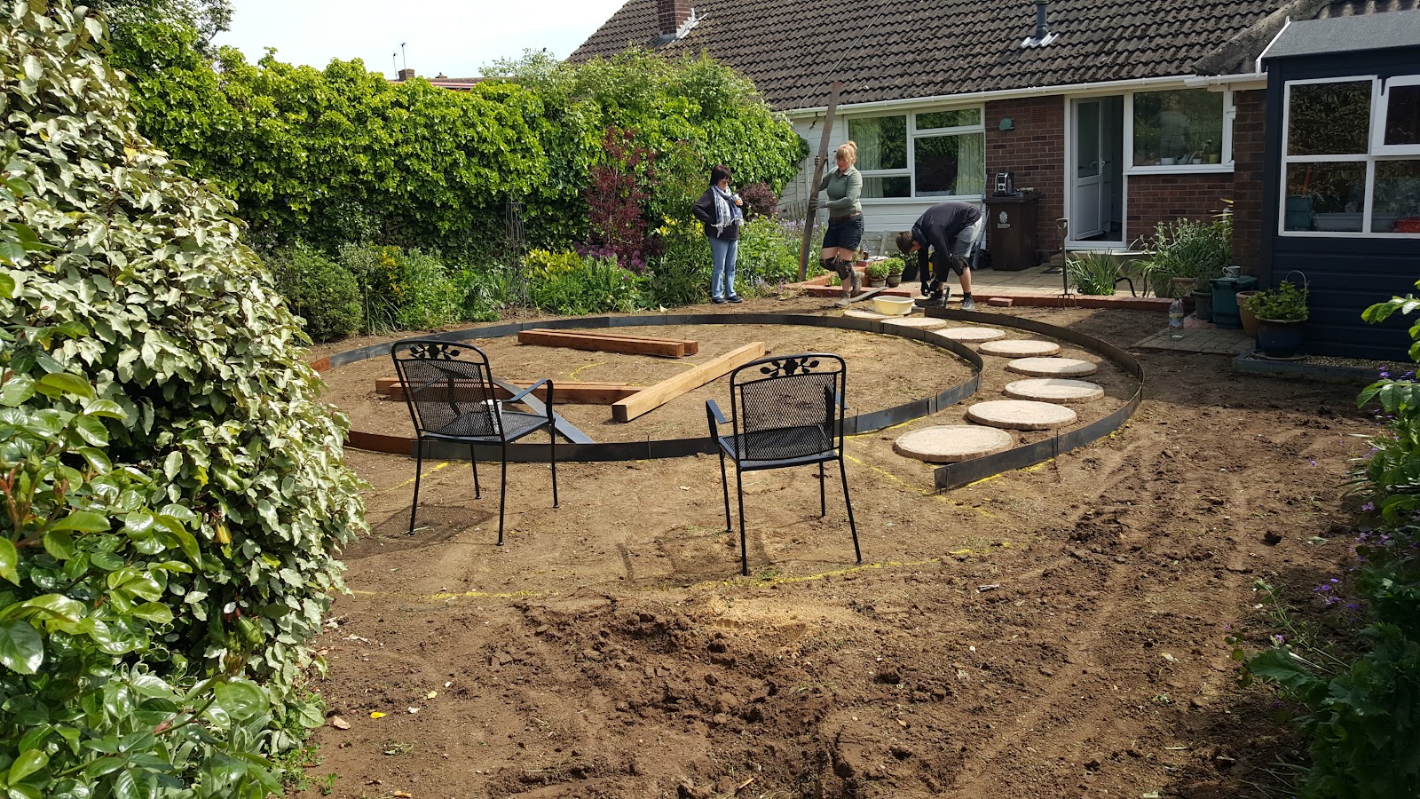 Circular garden feature under construction with stepping stones