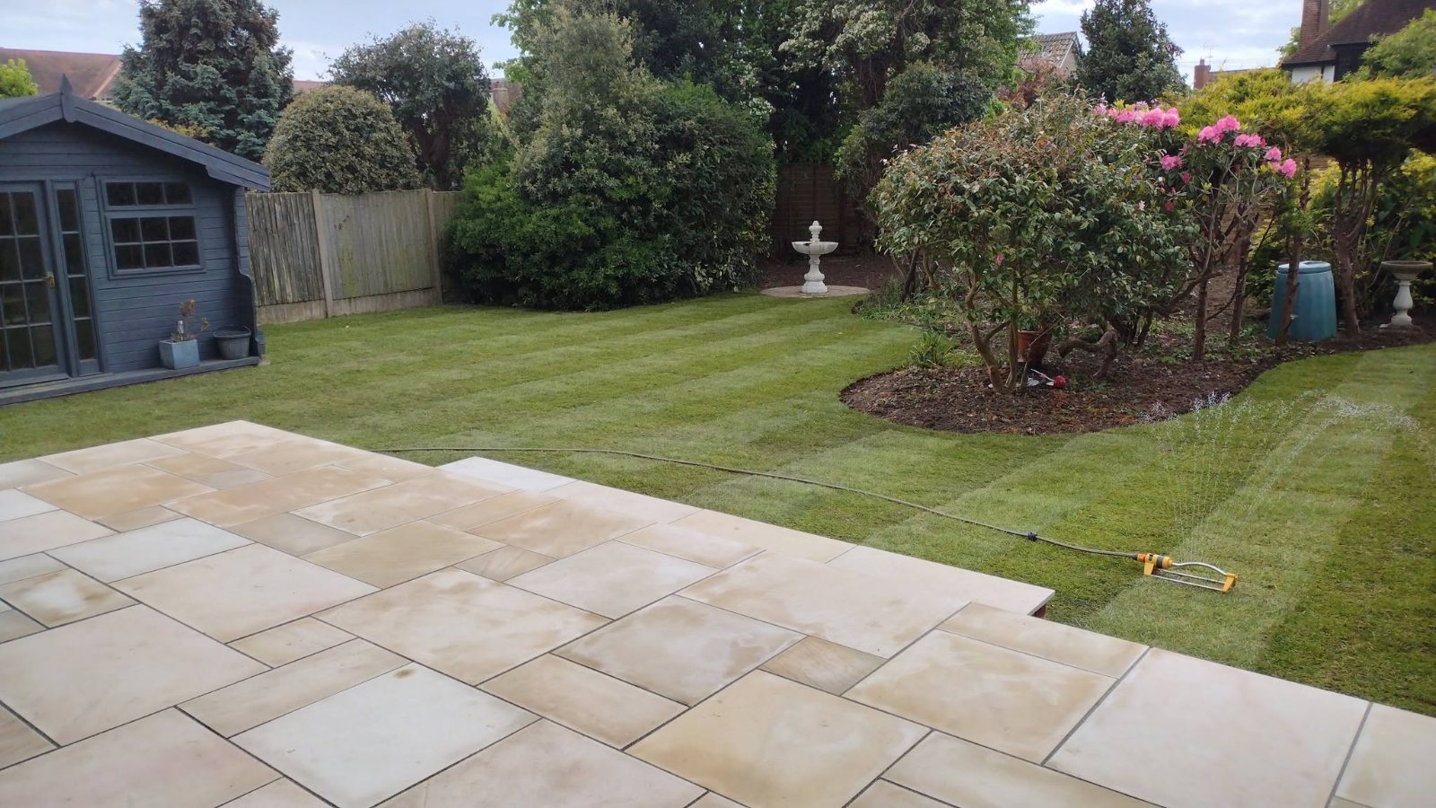 Completed front garden with new turf, charcoal edging and a block-paved driveway