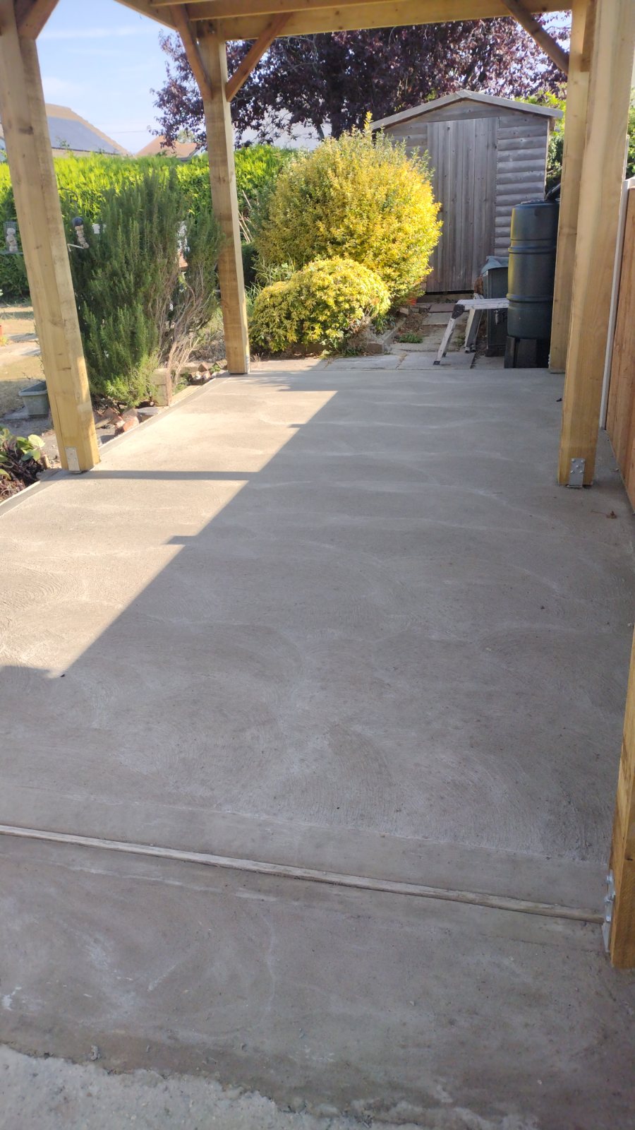 Curved brick-edged paths set out with a sleeper retaining wall