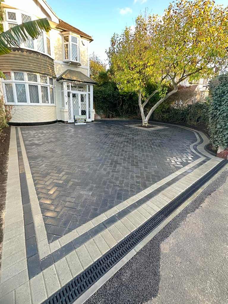 Front garden with new curved lawn and block-paved driveway